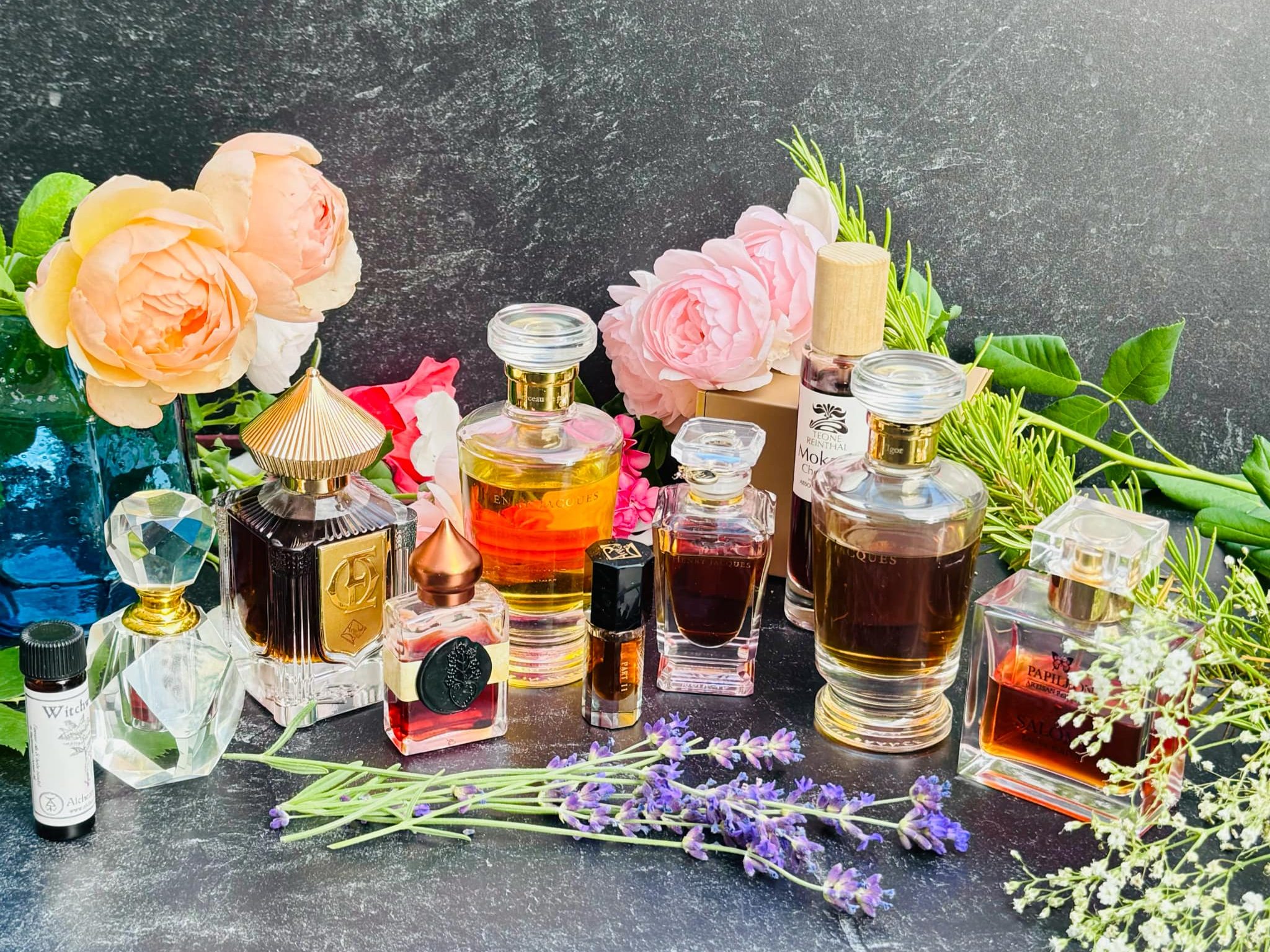Perfume bottles on a table with fresh flowers
