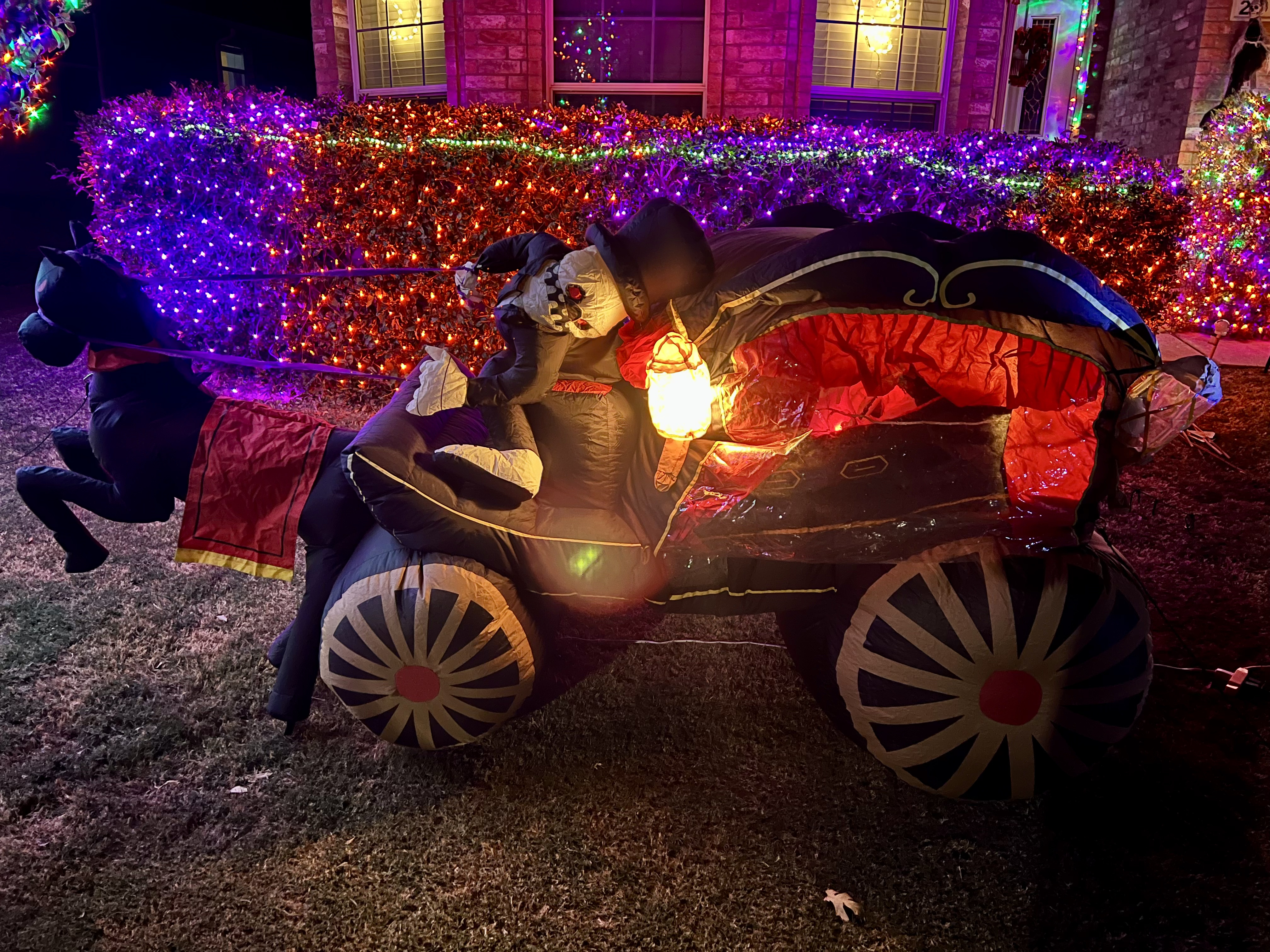 The blow up hearse set up outside surrounded by lights