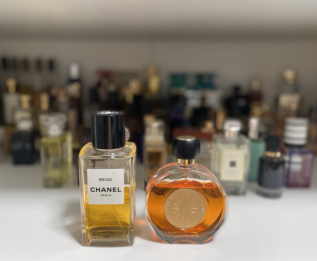 Two perfume bottles, one rectangular one round