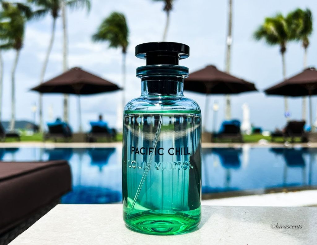A bottle of perfume near an outdoor pool