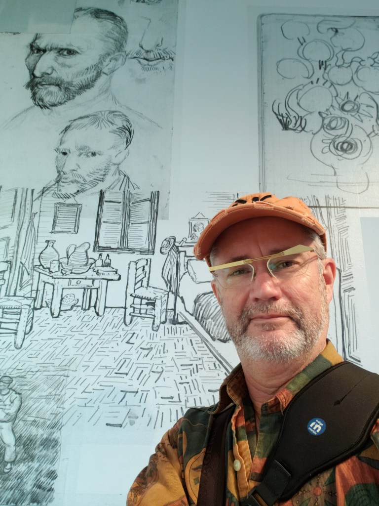 Paul Kiler standing in front of Van Gogh sketches and studies